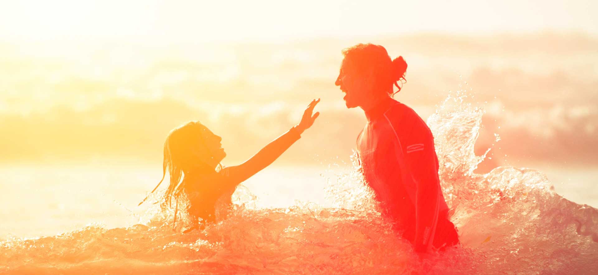 A sunrise image of a family enjoying the ocean